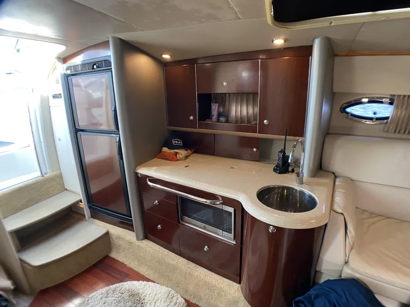 Slide: The Image of Interior of 2006 Formula 400 Super Sport yacht with kitchenette and seating area. - 26