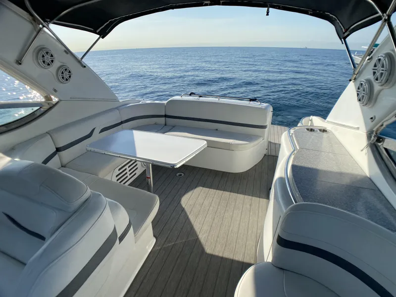Slide: The Image of 2006 Formula 400 Super Sport yacht interior with seating and table, overlooking the ocean. - 31