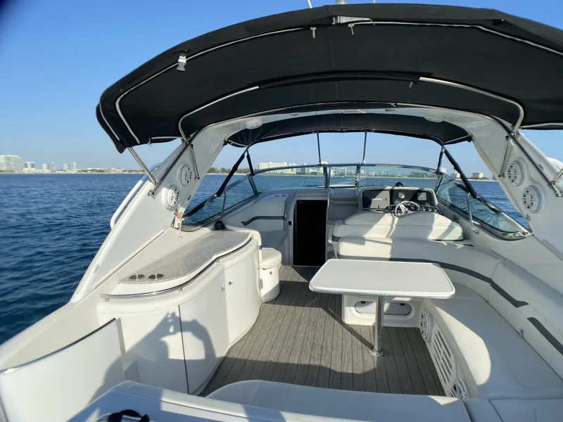 Slide: The Image of 2006 Formula 400 Super Sport boat interior with seating and table on open water. - 35