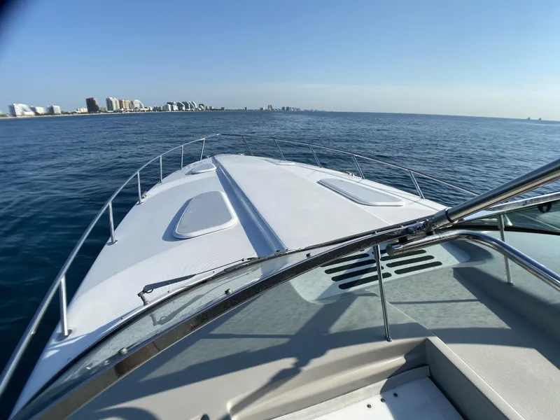 Slide: The Image of 2006 Formula 400 Super Sport yacht cruising on open water with city skyline in background. - 41