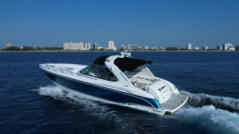 Slide: The Image of 2006 Formula 400 Super Sport yacht cruising on open water with city skyline backdrop. - 45