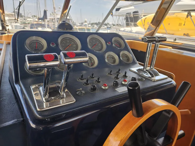 Slide: The Image of Control panel of a 1987 Riva SuperAmerica yacht with gauges and levers. - 12