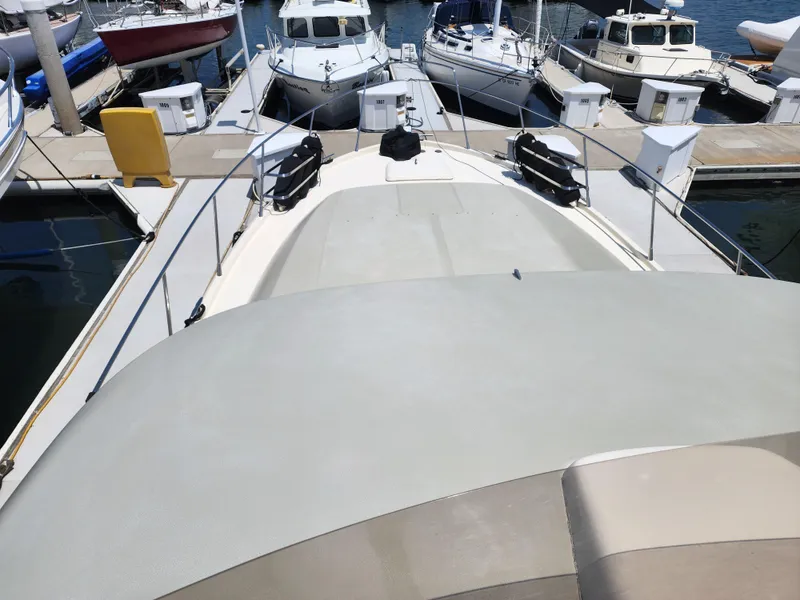 Slide: The Image of 1987 Riva SuperAmerica yacht docked at marina, surrounded by other boats. - 24
