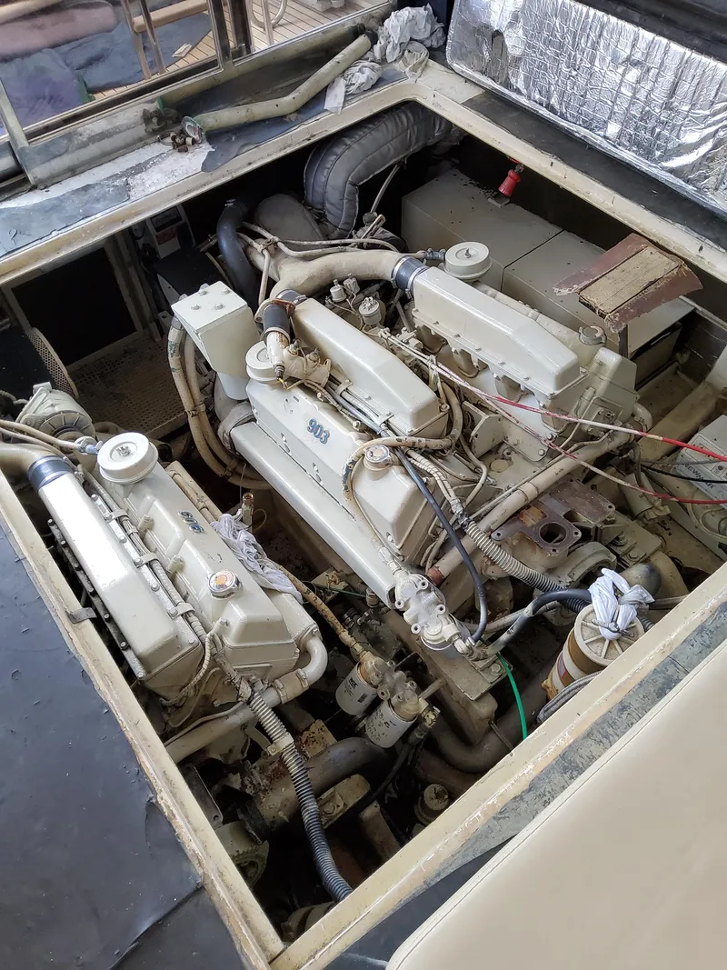 Slide: The Image of Engine compartment of a 1987 Riva SuperAmerica boat, showcasing dual engines and mechanical components. - 41