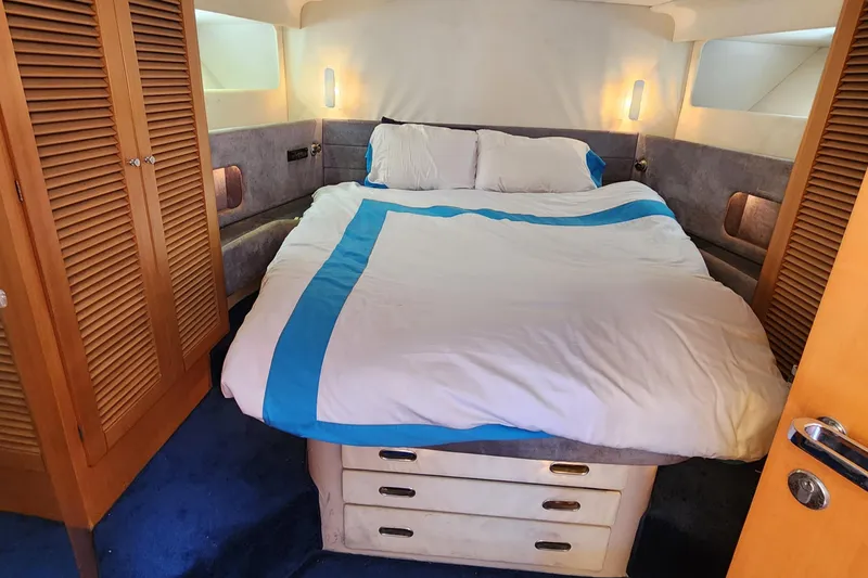 Slide: The Image of Cozy bedroom interior of 1987 Riva SuperAmerica yacht with double bed and wooden accents. - 18