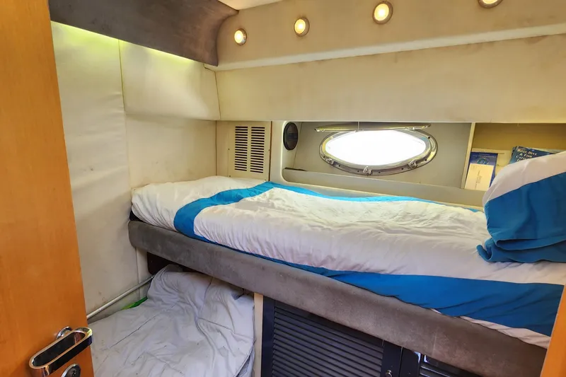 Slide: The Image of Interior cabin of 1987 Riva SuperAmerica yacht with bunk beds and porthole window. - 19