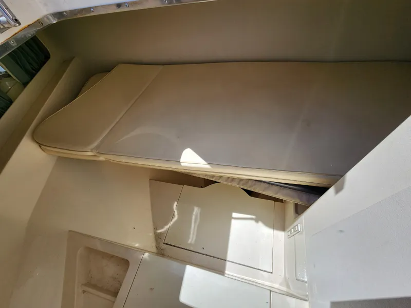 Slide: The Image of 1987 Riva SuperAmerica boat interior with beige seating and storage compartments. - 21