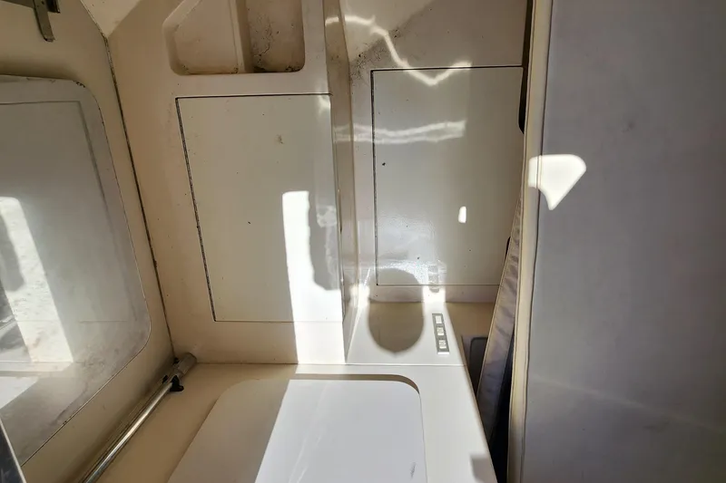 Slide: The Image of 1987 Riva SuperAmerica yacht bathroom interior with white fixtures and compact design. - 22