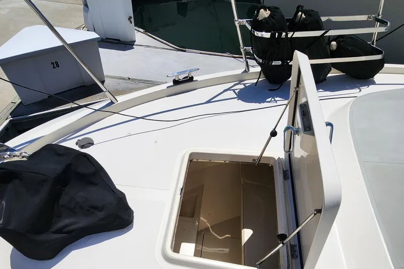 Slide: The Image of 1987 Riva SuperAmerica yacht deck with open hatch and docked setting. - 27