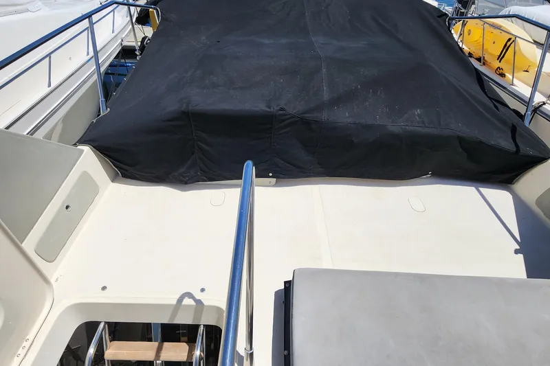 Slide: The Image of 1987 Riva SuperAmerica yacht deck with black cover and railing. - 28