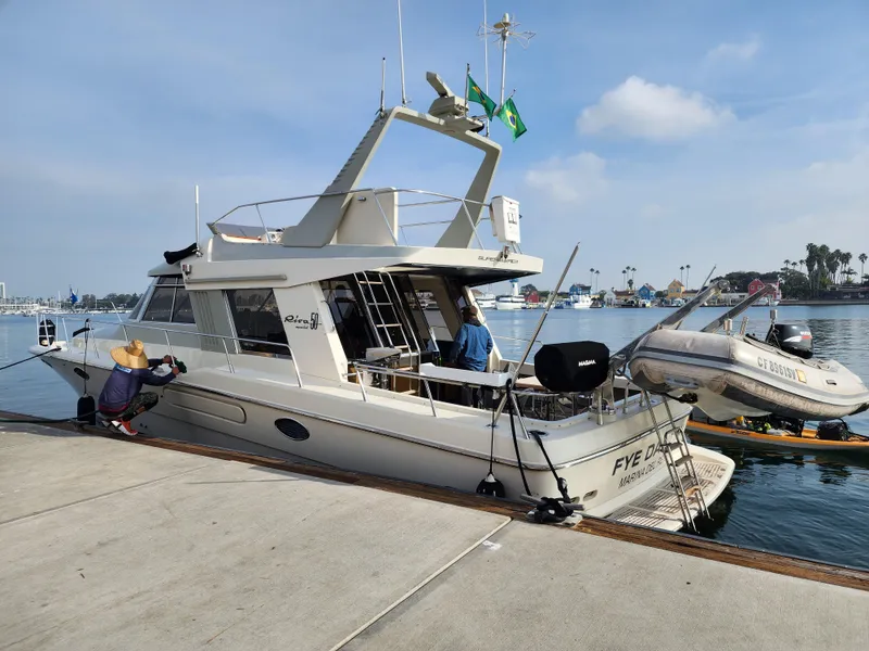 Slide: The Image of 1987 Riva SuperAmerica yacht docked at marina with inflatable boat attached. - 3