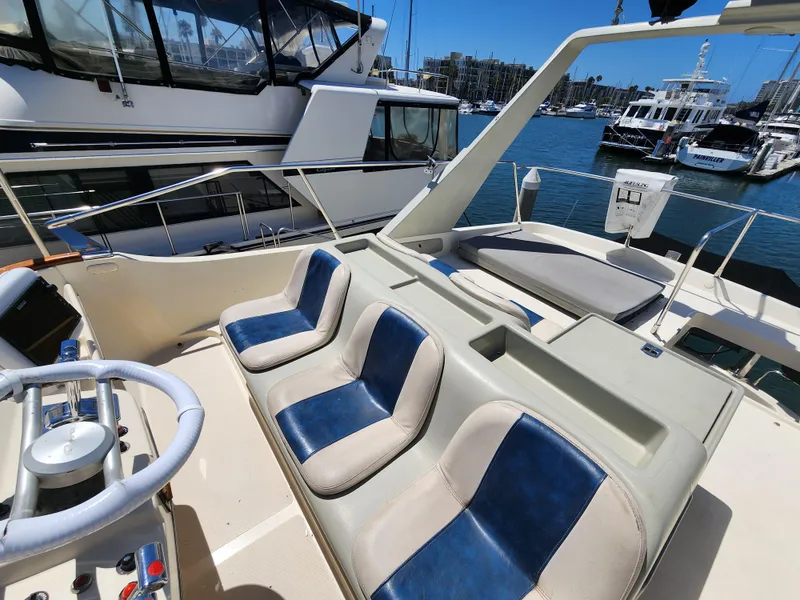 Slide: The Image of 1987 Riva SuperAmerica yacht interior with blue and white seating, docked in a marina. - 32