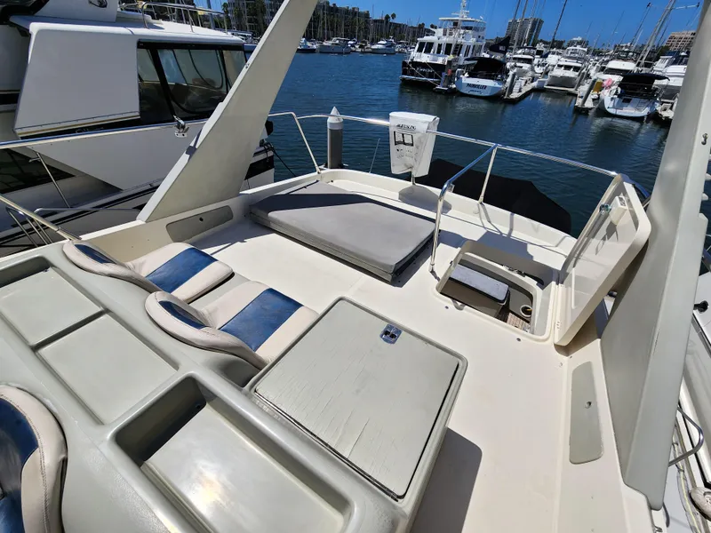 Slide: The Image of 1987 Riva SuperAmerica yacht deck with seating, docked in a marina. - 34