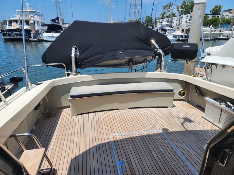 Slide: The Image of 1987 Riva SuperAmerica yacht deck with seating, docked in a marina. - 37