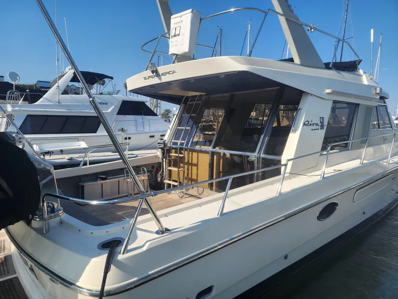 Slide: The Image of 1987 Riva SuperAmerica yacht docked at a marina under clear blue skies. - 4