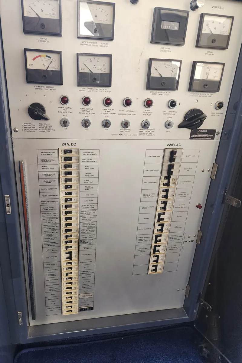 Slide: The Image of Electrical control panel of a 1987 Riva SuperAmerica yacht with gauges and switches. - 42