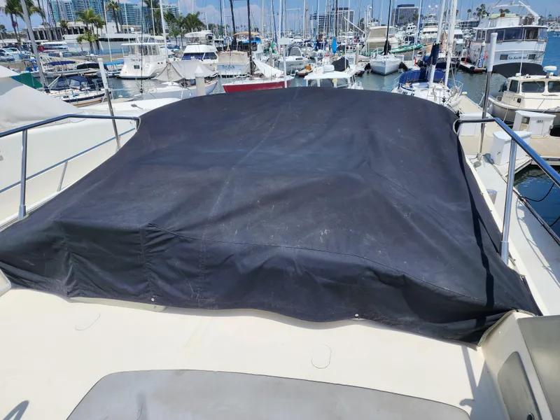 Slide: The Image of Covered deck of a 1987 Riva SuperAmerica yacht in a marina. - 46