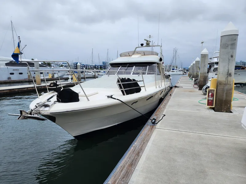 Slide: The Image of 1987 Riva SuperAmerica yacht docked at marina under cloudy skies. - 51