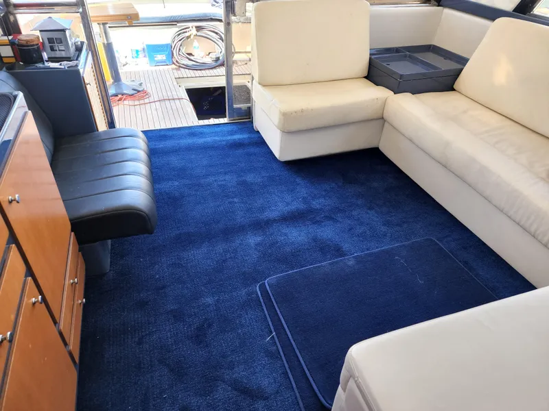 Slide: The Image of Interior of 1987 Riva SuperAmerica yacht with blue carpet and white seating. - 6