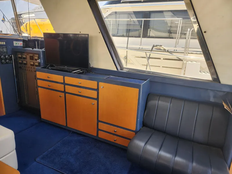 Slide: The Image of Interior of 1987 Riva SuperAmerica yacht with wooden cabinets and leather seating. - 8