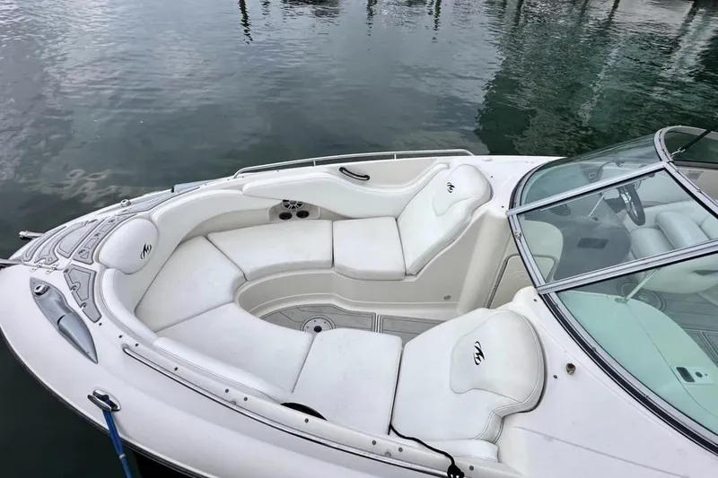 Slide: The Image of 2009 Monterrey 278s boat with white seating, docked on calm water. - 12