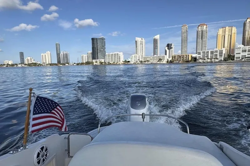 Slide: The Image of Boat cruising near city skyline, Monterrey 278s, 2009, with American flag. - 15