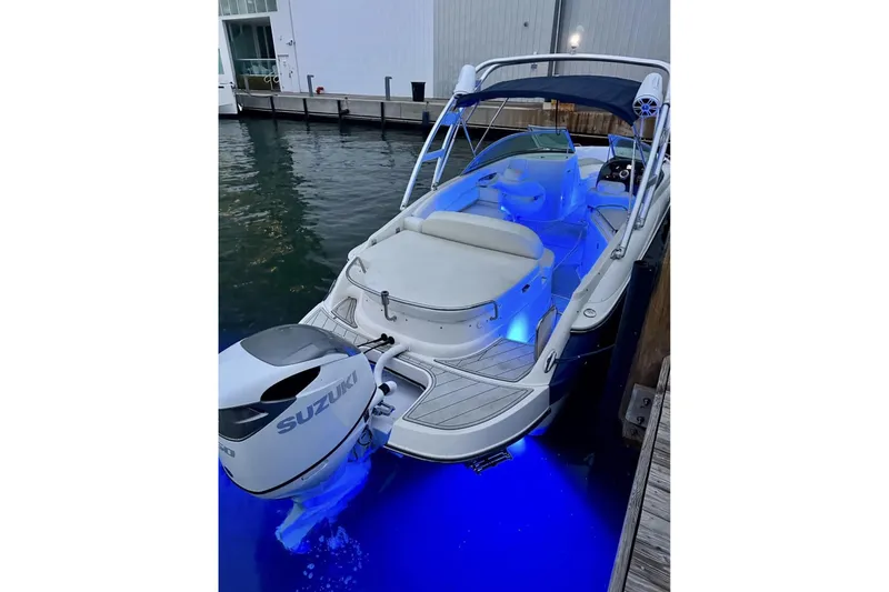 Slide: The Image of 2009 Monterrey 278s boat with Suzuki engine, docked, featuring blue LED lighting. - 16