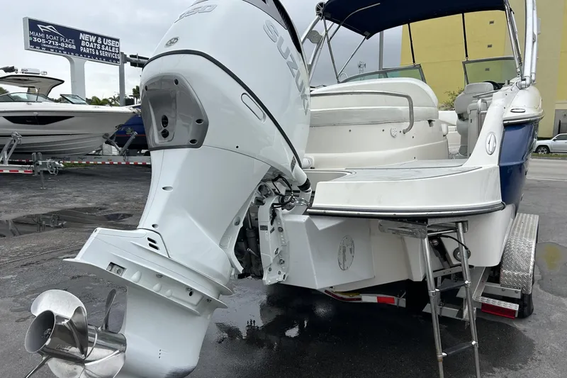 Slide: The Image of 2009 Monterey 278 SSC boat with Suzuki outboard motor, displayed at a dealership. - 21