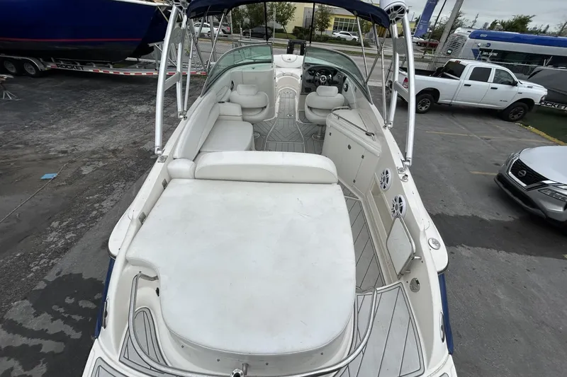 Slide: The Image of 2009 Monterey 278 SSC boat interior with seating and steering wheel, parked outdoors. - 22