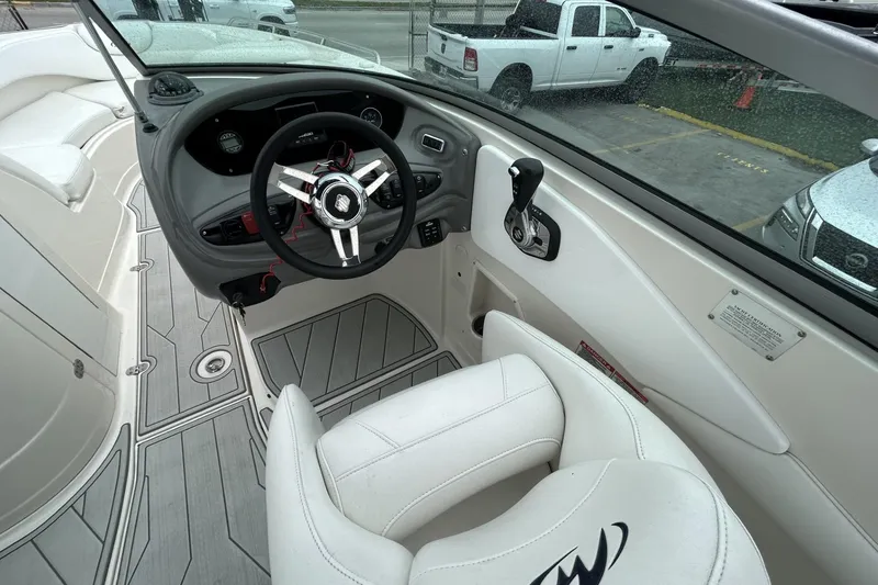 Slide: The Image of Interior view of a 2009 Monterey 278 SSC boat cockpit with steering wheel and controls. - 23