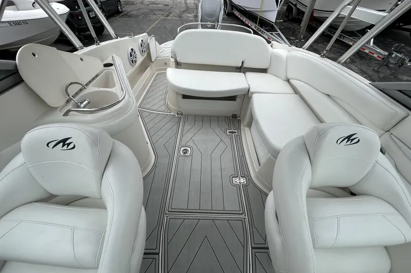Slide: The Image of Interior of a 2009 Monterey 278 SSC boat with white seating and sleek design. - 24