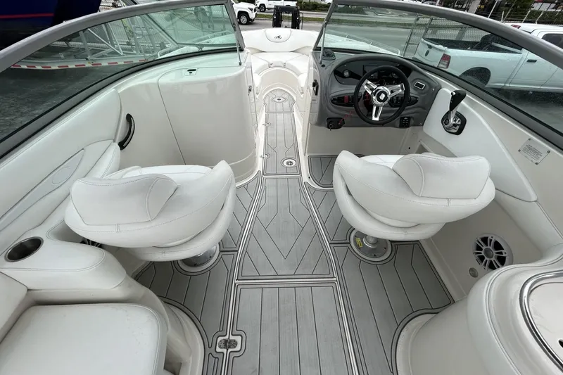 Slide: The Image of Interior of a 2009 Monterey 278 SSC boat with white seating and modern dashboard. - 25