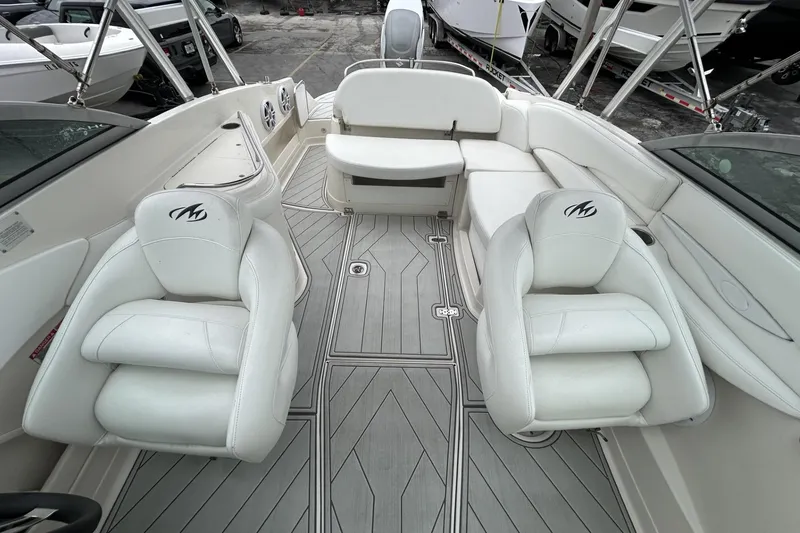 Slide: The Image of 2009 Monterey 278 SSC boat interior with white seating and sleek flooring design. - 27