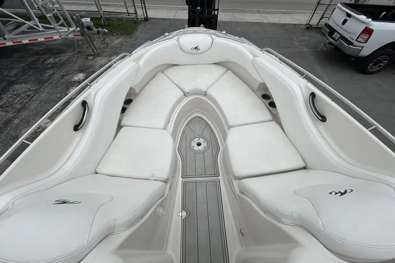 Slide: The Image of 2009 Monterey 278 SSC boat interior with white cushioned seating and sleek design. - 28