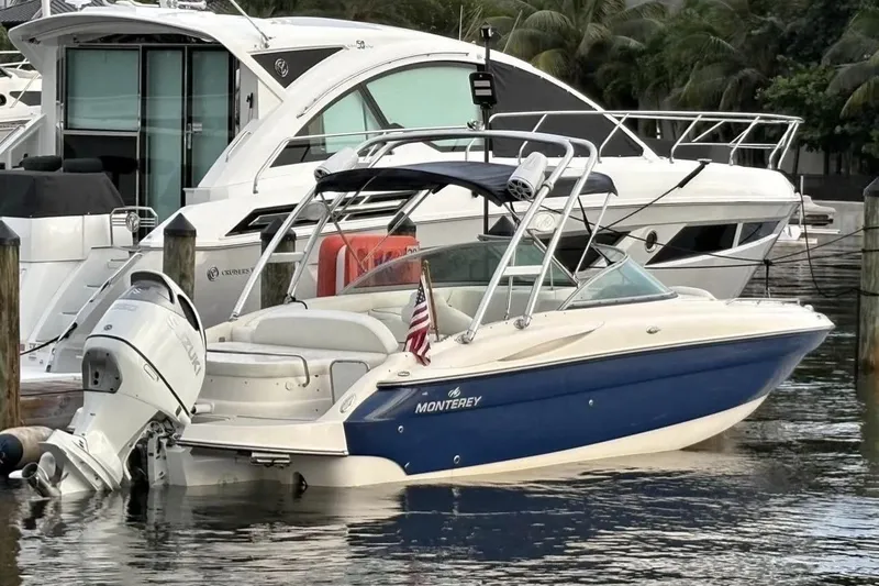 Slide: The Image of 2009 Monterey 278 SSC boat in a marina, surrounded by other vessels. - 3
