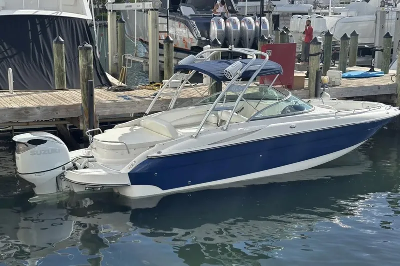 Slide: The Image of 2009 Monterey 278 SSC boat with spacious seating and sleek design in a marina setting. - 5