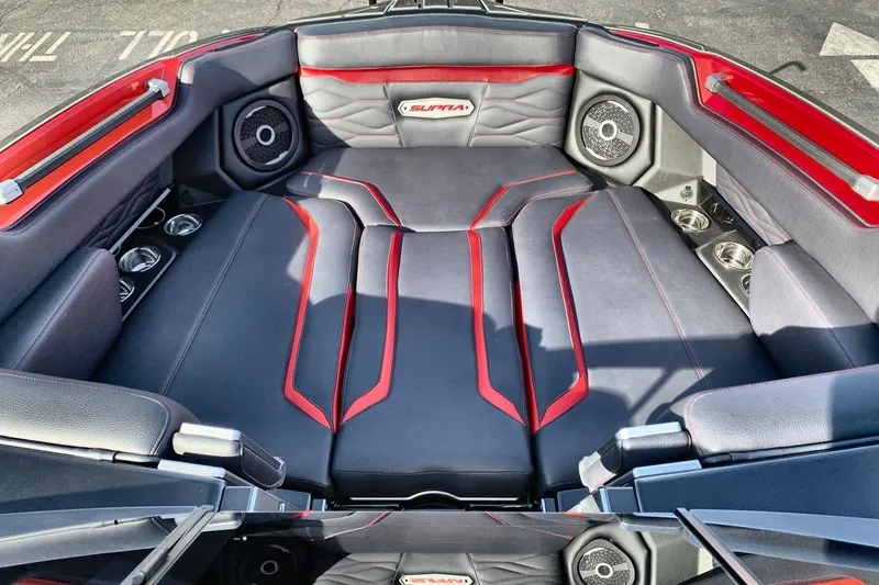 Slide: The Image of 2026 Supra SL 550 interior with red accents and premium audio system. - 11