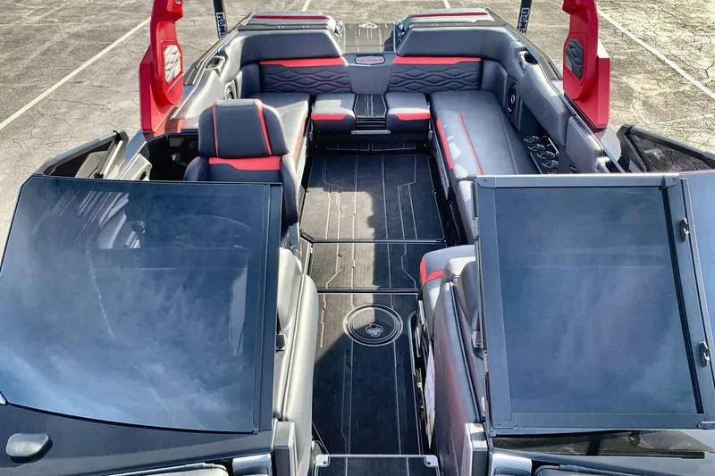 Slide: The Image of 2026 Supra SL 550 boat interior with red and gray seating, open layout. - 12