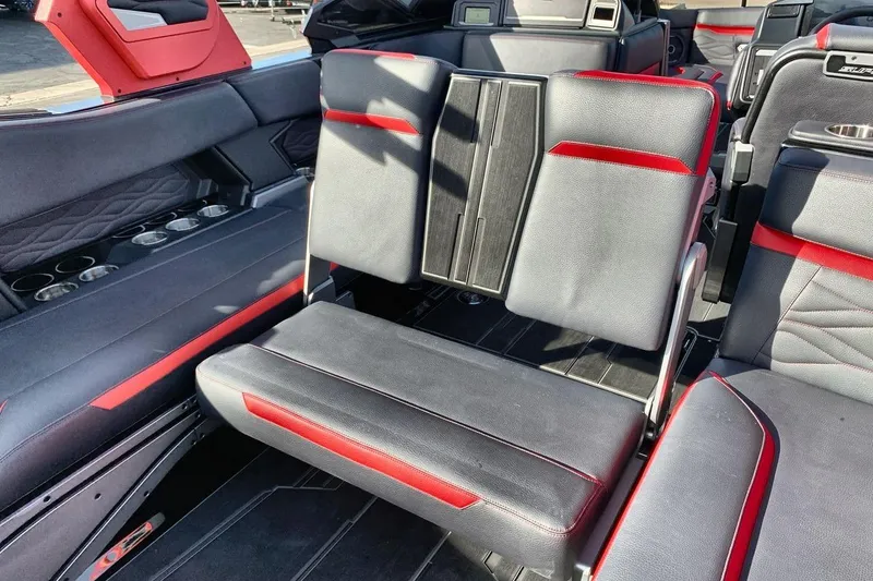 Slide: The Image of 2026 Supra SL 550 interior with black and red seating, cup holders, and modern design. - 24