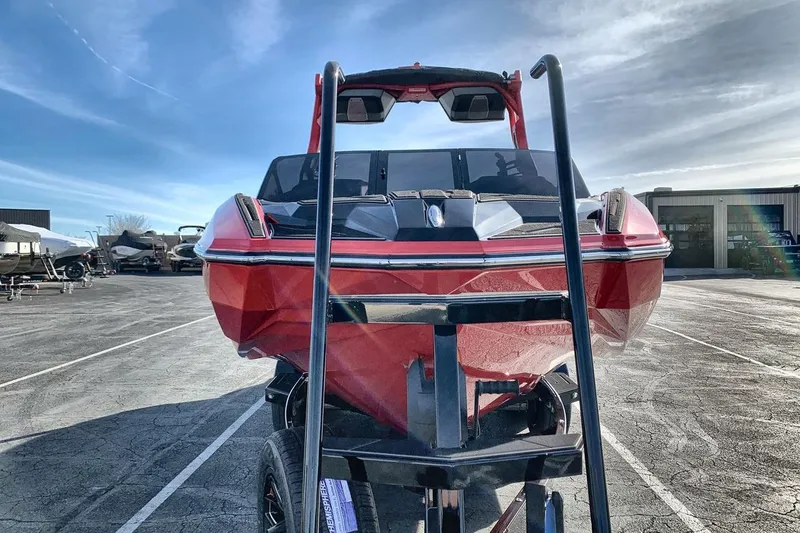 Slide: The Image of 2026 Supra SL 550 boat on trailer under clear sky. - 8