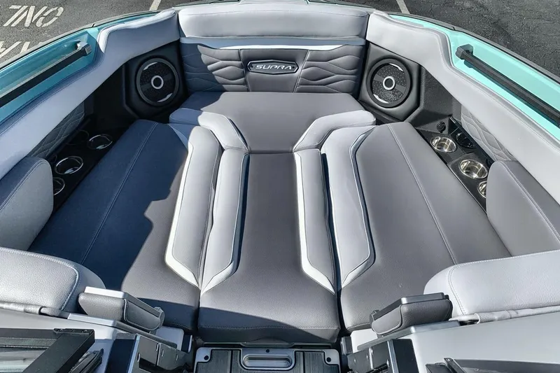 Slide: The Image of 2026 Supra SL 550 boat interior with gray seating and built-in speakers. - 11