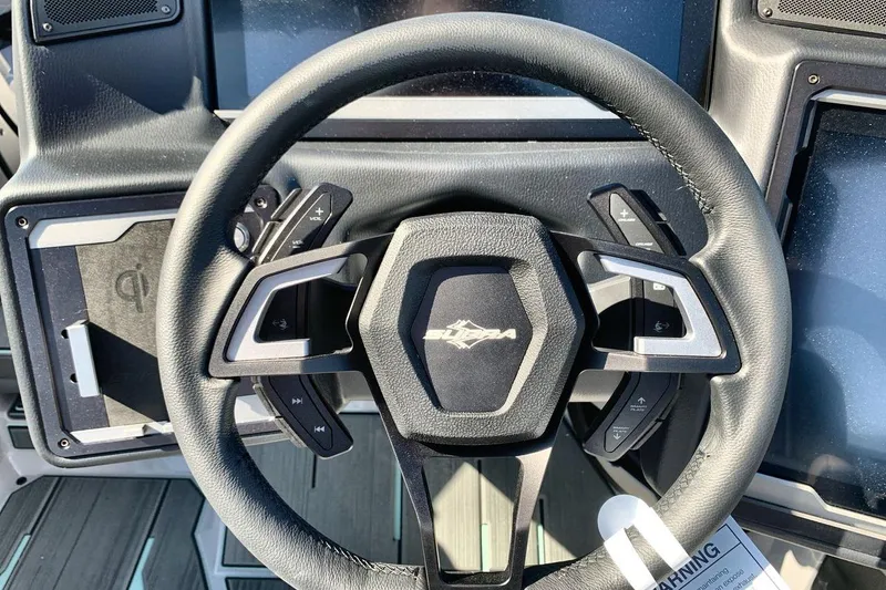 Slide: The Image of Steering wheel of 2026 Supra SL 550 with modern controls and logo. - 14