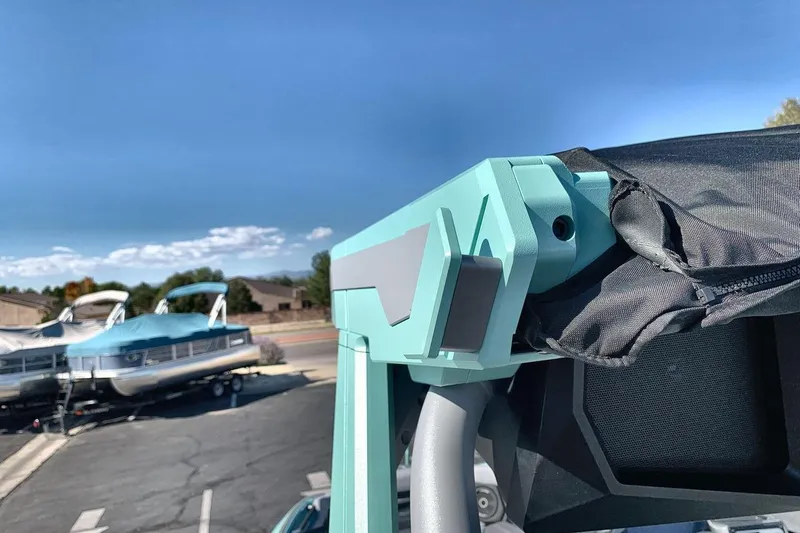 Slide: The Image of 2026 Supra SL 550 boat detail with turquoise accents and covered seating area. - 25