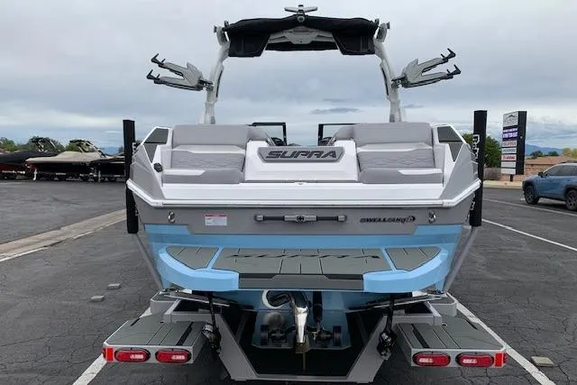 Slide: The Image of 2026 Supra SA 450 boat, rear view, in parking lot, showcasing sleek design and features. - 4
