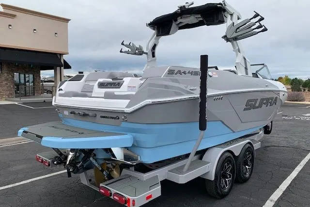 Slide: The Image of 2026 Supra SA 450 boat on trailer, parked outdoors, showcasing sleek design and modern features. - 5