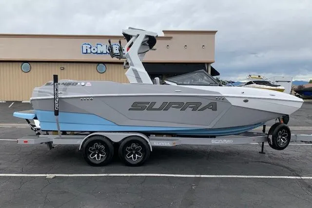 Slide: The Image of 2026 Supra SA 450 boat on trailer, parked outside a building. - 6