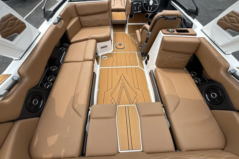 Slide: The Image of Luxurious interior of 2025 Supra SA 550 boat with tan leather seating and sleek design. - 10