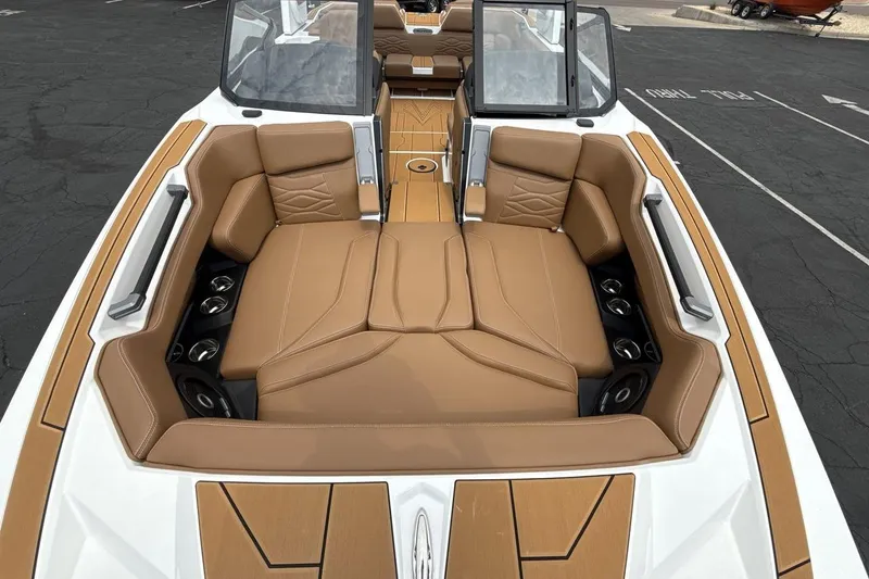 Slide: The Image of 2025 Supra SA 550 boat interior with tan leather seating and modern design. - 12