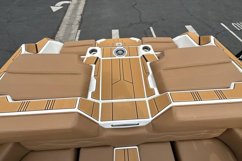 Slide: The Image of 2025 Supra SA 550 boat interior with tan leather seats and wood accents. - 19