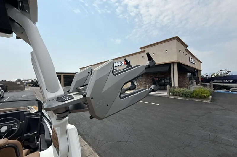 Slide: The Image of 2025 Supra SA 550 boat with advanced wakeboard rack near dealership. - 22